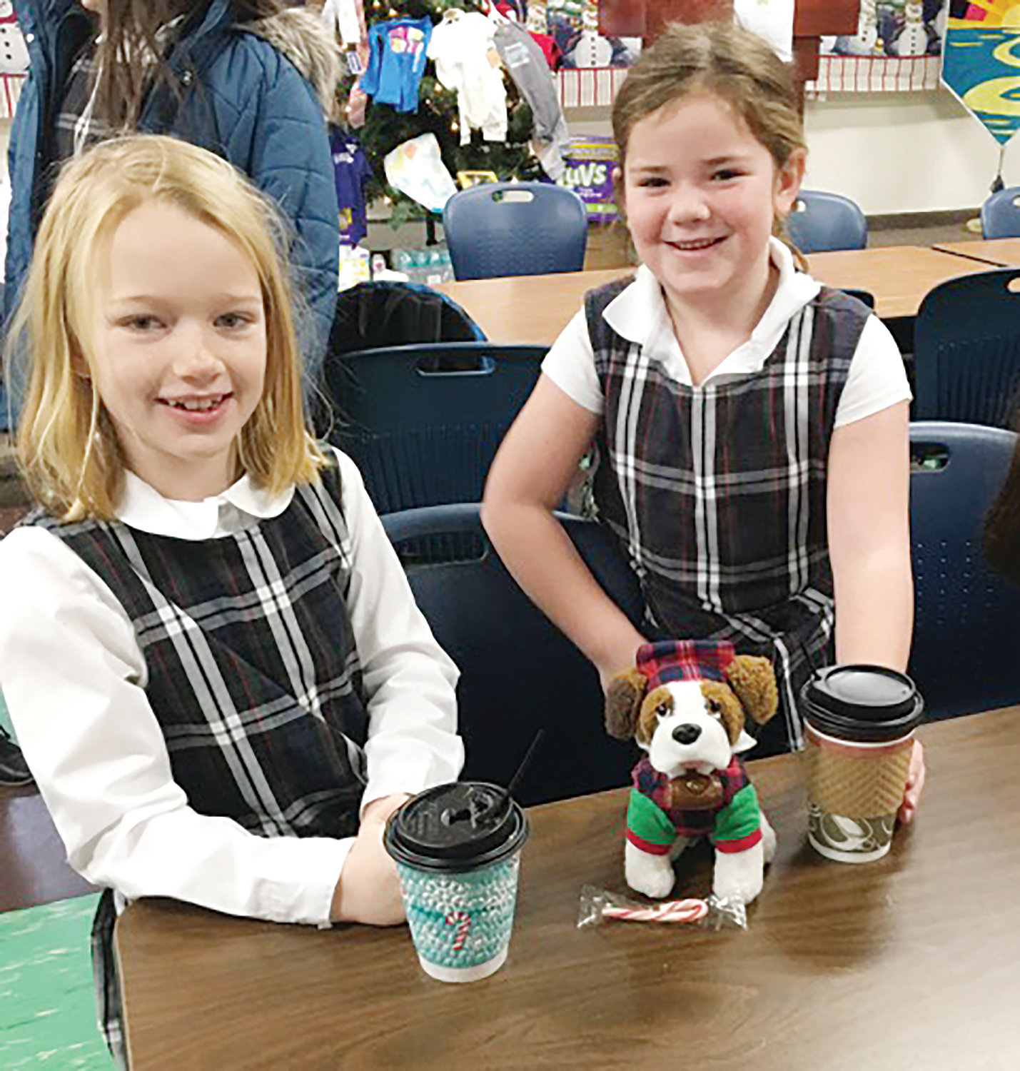 Second graders Michaela O’Connor and Skylar Murphy enjoy some cocoa. 